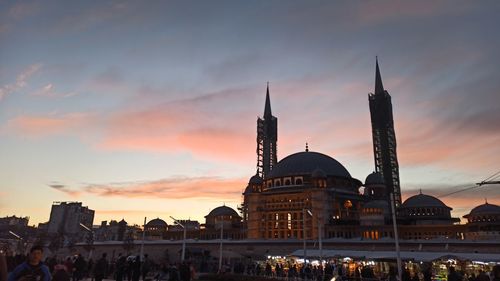 View of buildings in city at sunset