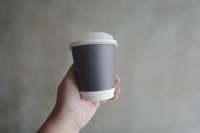 Midsection of person holding coffee cup