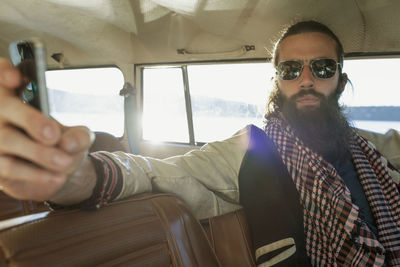 Handsome young man sitting in a car