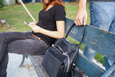 Rear view of woman using mobile phone