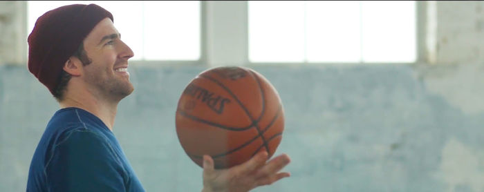 Side view of man holding ball