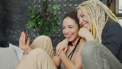 Young woman sitting on smiling while holding hands