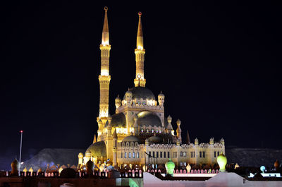Illuminated cathedral against sky at night