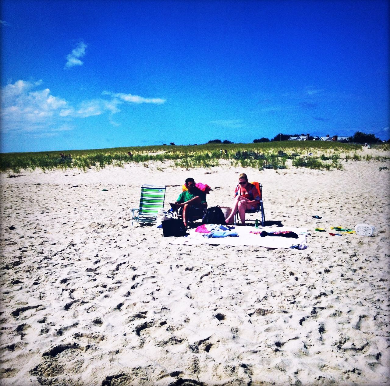 sand, beach, real people, sky, men, day, outdoors, togetherness, leisure activity, nature, transportation, vacations, sitting, water, women, scenics, beauty in nature, landscape, people