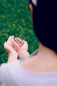 Woman with grass flower in her hands