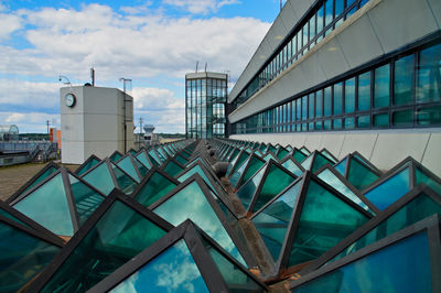 Low angle view of glass pyramids against sky