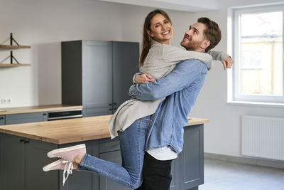 Young couple embracing at home