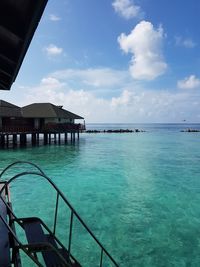 Scenic view of swimming pool by sea against sky
