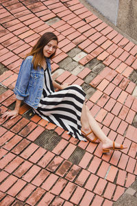 Full length of woman sitting outdoors