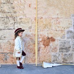 Full length of woman standing on sidewalk