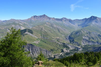 Scenic view of mountains against blue sky