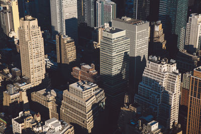 View of skyscrapers in city at sunset