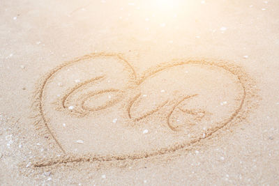 Close-up of heart shape on sand