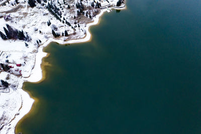 Aerial view of lake by snow covered town