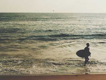 Man on beach against sky