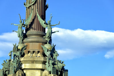 Low angle view of statue against blue sky