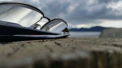 Close-up of sunglasses on beach