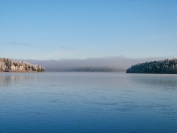 Scenic view of lake against clear blue sky