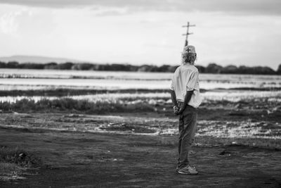 Rear view of man standing on beach