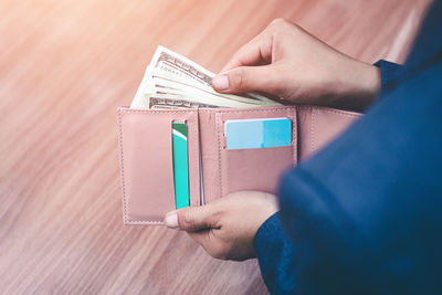 Midsection of person holding paper