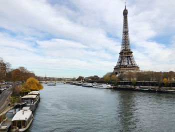 River in city against cloudy sky