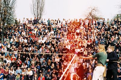 Crowd at music concert against sky