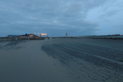 Scenic view of beach against sky in city