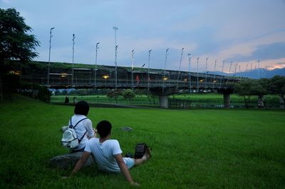 People sitting on grassy field