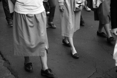 Low section of people walking on street