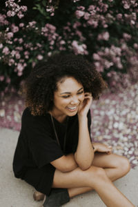 Young woman smiling while sitting outdoors