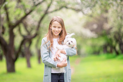 Portrait of a smiling young man holding a dog