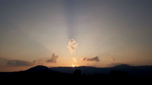 Scenic view of silhouette mountains against sky during sunset