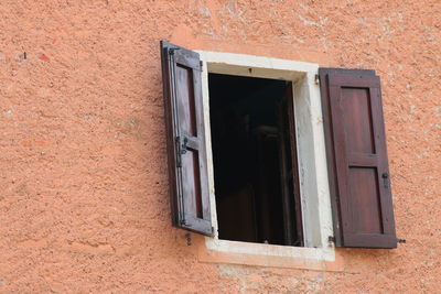 Low angle view of open house window