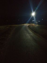 Empty road in city at night