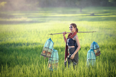 Man holding umbrella on field