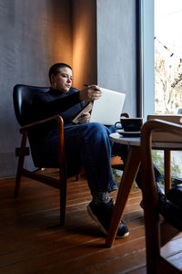 Young woman using laptop at home