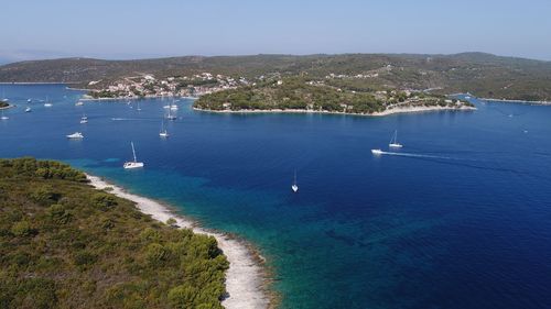 High angle view of sea against clear blue sky