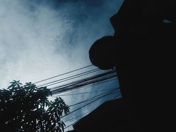 Low angle view of silhouette man against sky