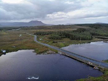 Scenic view of landscape and lake against sky