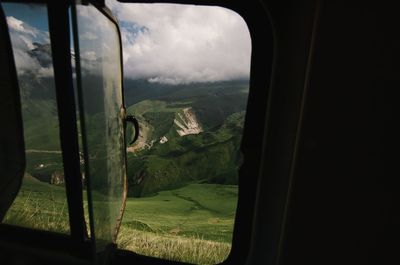 Scenic view of landscape seen through glass window