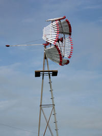 Low angle view of weather vane against sky