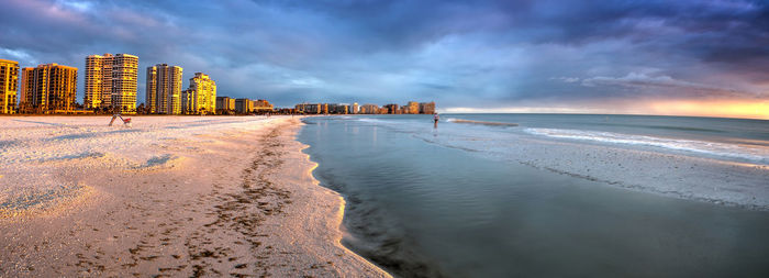 Scenic view of beach against sky during sunset