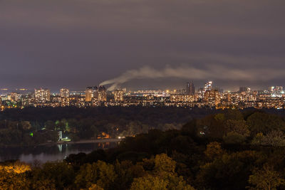 Illuminated cityscape against sky at night