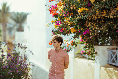 Man standing by flowering plants