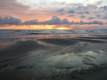 View of beach against cloudy sky