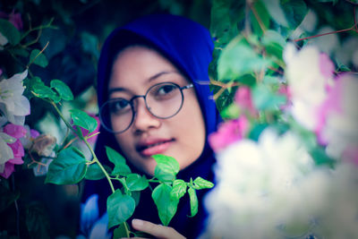 Portrait of woman with pink flowers