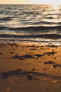 Close-up of waves on beach against sky