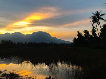 Scenic view of lake against sky during sunset