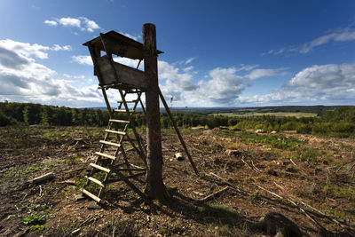 Lifeguard hut on field against sky