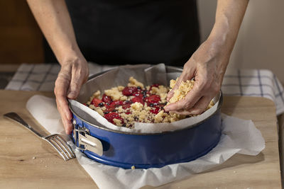 Midsection of person preparing food on table